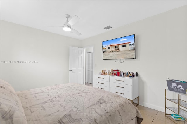 tiled bedroom featuring ceiling fan