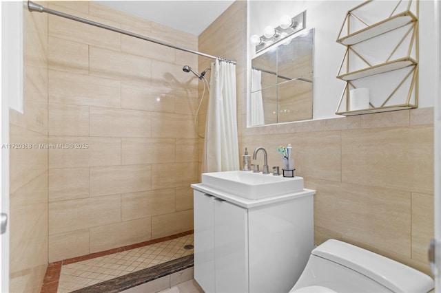 bathroom with curtained shower, vanity, tile walls, and toilet