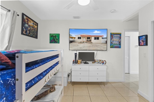 tiled bedroom featuring ceiling fan