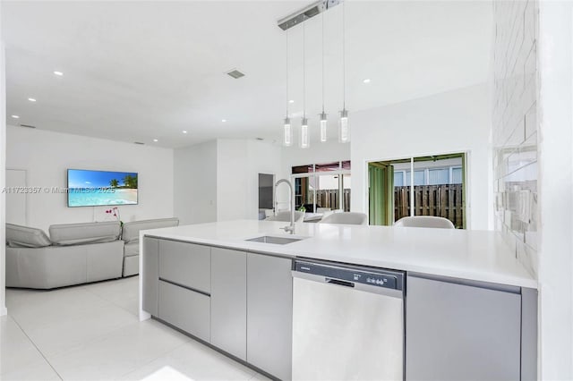 kitchen featuring stainless steel dishwasher, decorative light fixtures, light tile patterned floors, and sink