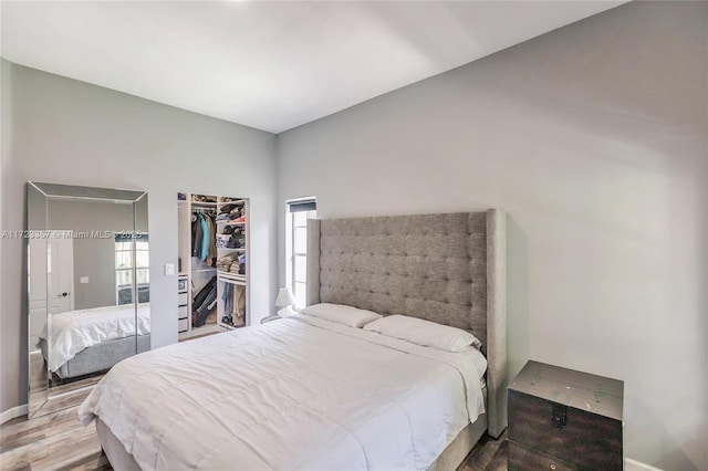 bedroom with wood-type flooring and a closet