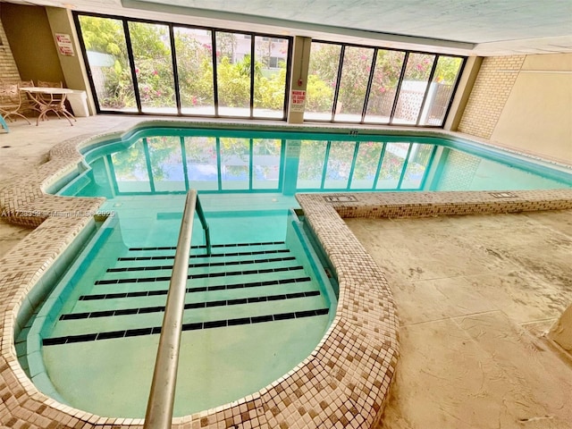 view of pool with a hot tub