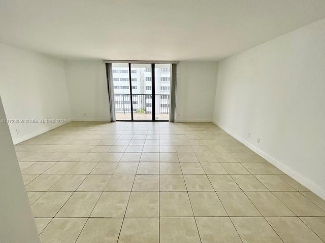 tiled spare room with expansive windows