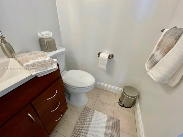 bathroom featuring toilet, vanity, and tile patterned floors