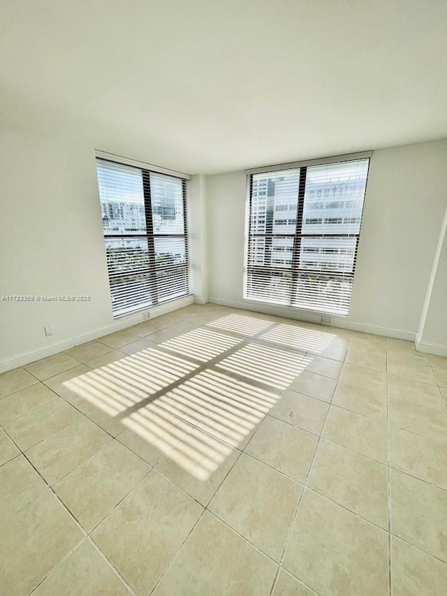 spare room with light tile patterned floors