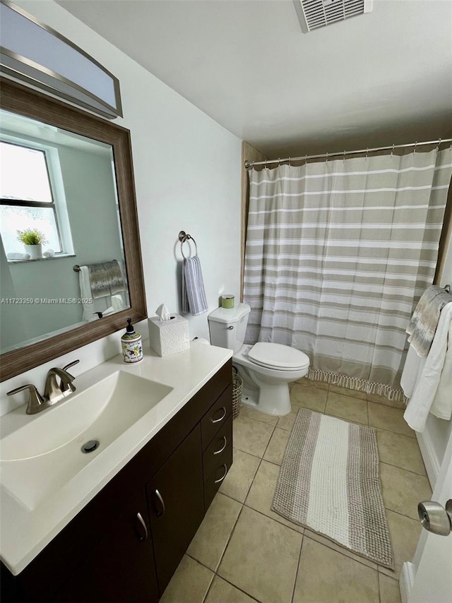 bathroom featuring tile patterned flooring, vanity, and toilet