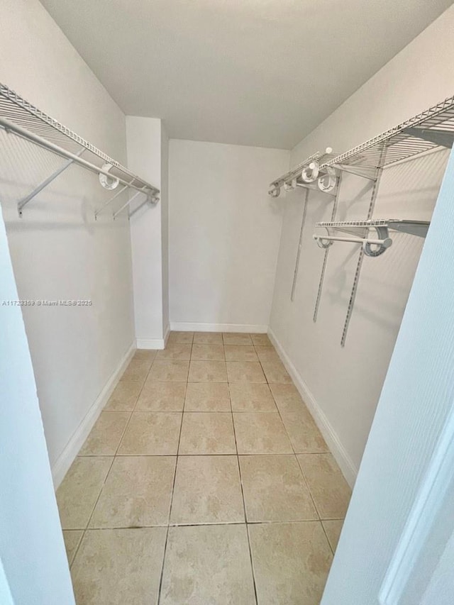 spacious closet with tile patterned flooring