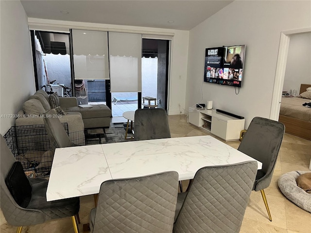 dining area featuring vaulted ceiling