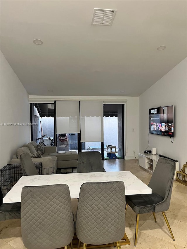 dining space featuring vaulted ceiling