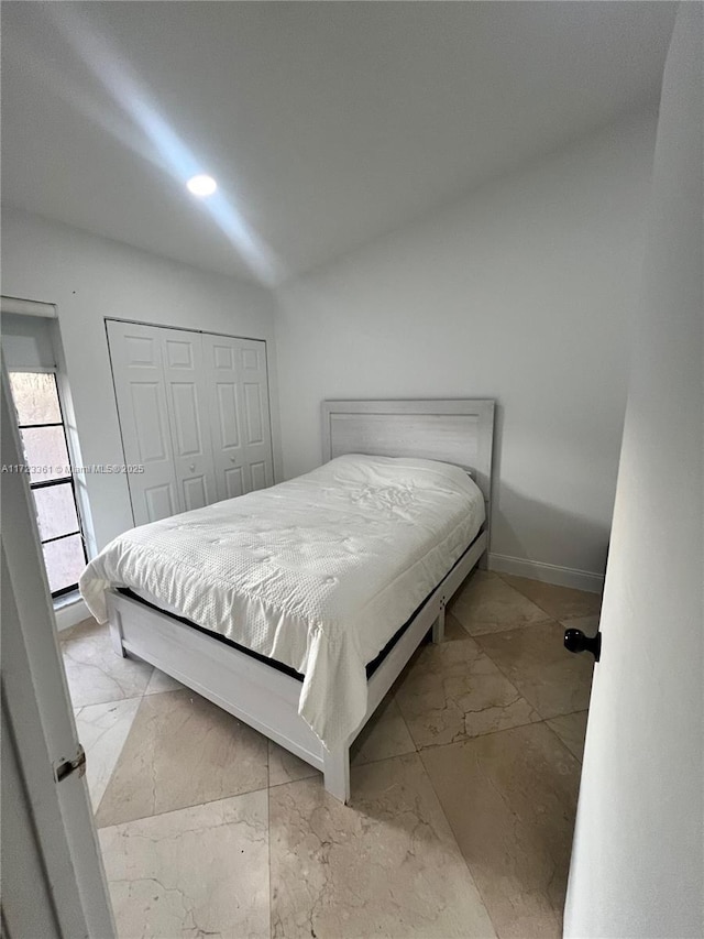 bedroom with a closet and lofted ceiling