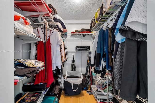 walk in closet with hardwood / wood-style floors