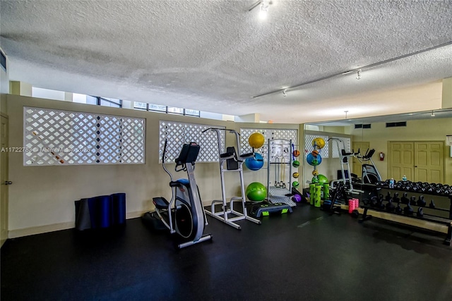 workout area with a textured ceiling