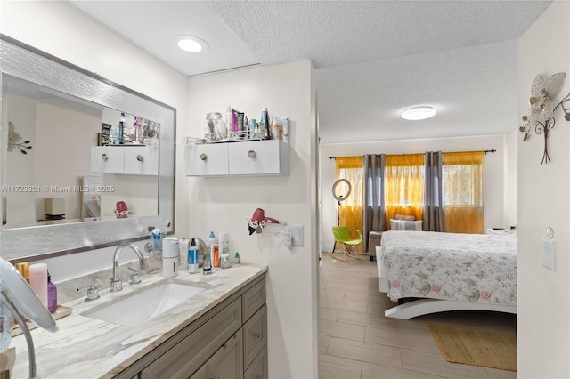 bathroom with vanity and a textured ceiling