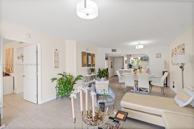 dining space featuring a textured ceiling