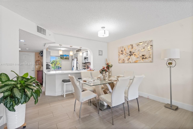 dining area featuring a textured ceiling