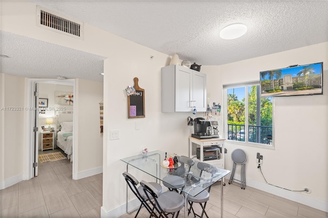 dining room with a textured ceiling