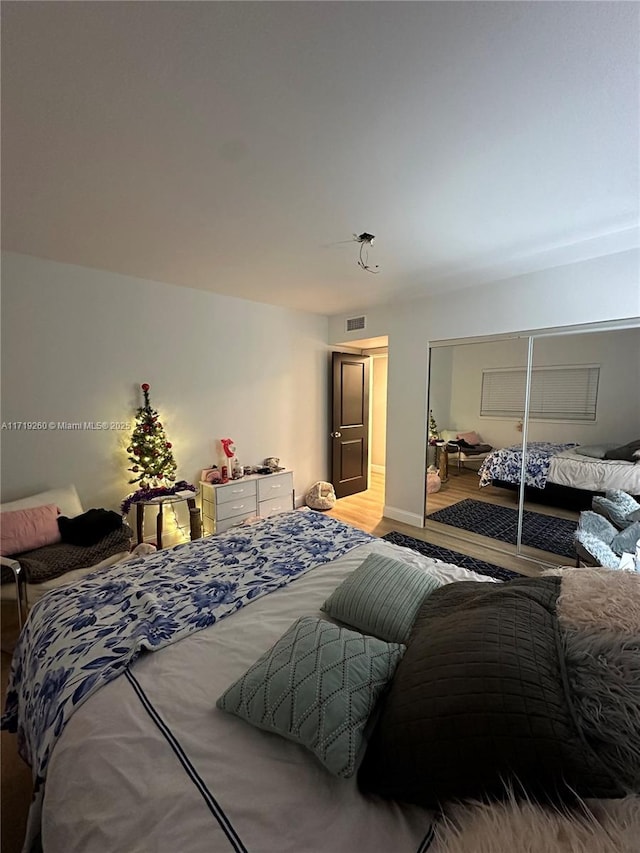 bedroom with hardwood / wood-style floors and a closet