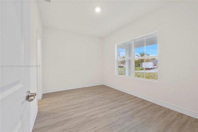 spare room featuring light hardwood / wood-style flooring