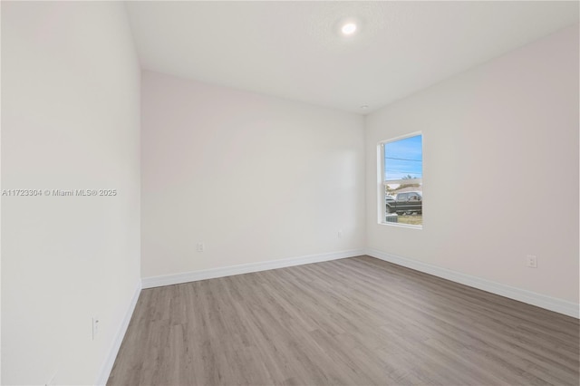 unfurnished room with light hardwood / wood-style floors