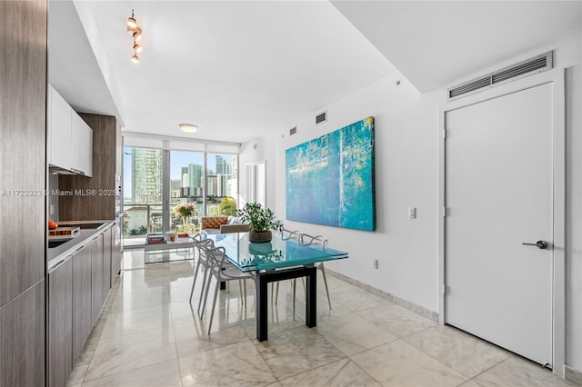 2900 NE 7th Ave Unit 908, Miami, FL 33137 - dining area with a wall of windows, light marble finish floors, and a city view