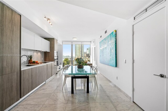 2900 NE 7th Ave Unit 908, Miami, FL 33137 - dining room with baseboards and light marble finish flooring