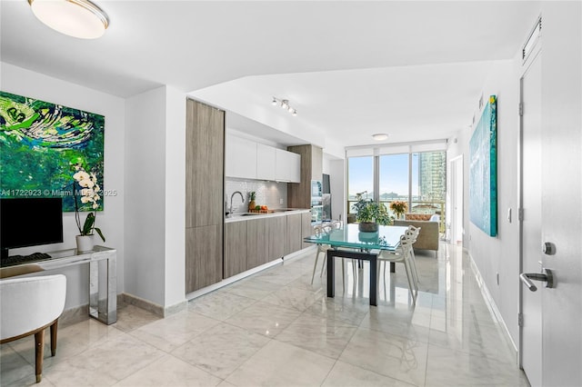 2900 NE 7th Ave Unit 908, Miami, FL 33137 - dining room with baseboards and light marble finish floors