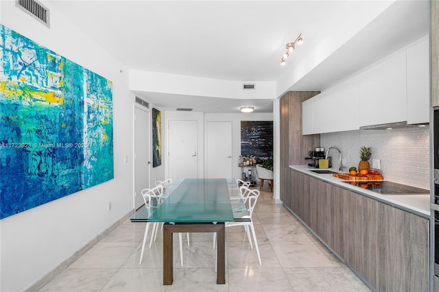 2900 NE 7th Ave Unit 908, Miami, FL 33137 - dining room featuring light marble finish flooring and baseboards