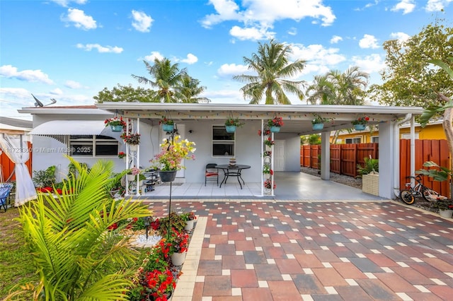 rear view of property with a carport