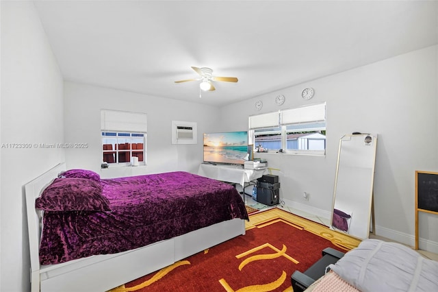 bedroom featuring a wall mounted air conditioner and ceiling fan