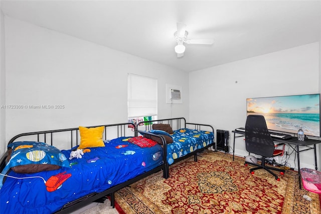 bedroom featuring an AC wall unit and ceiling fan