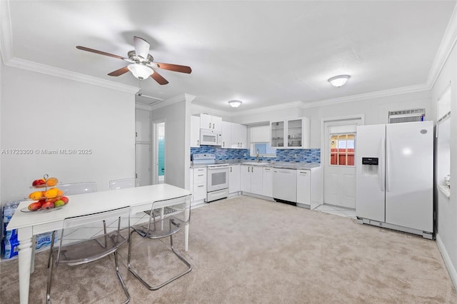 kitchen featuring white cabinetry, sink, white appliances, and ornamental molding