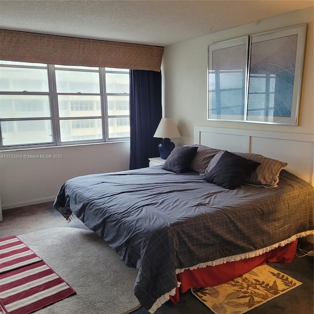 bedroom featuring carpet and a textured ceiling