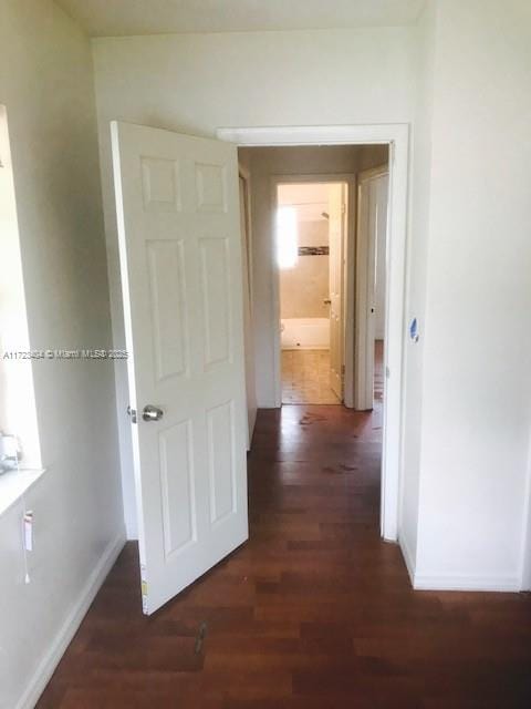 corridor featuring dark hardwood / wood-style floors