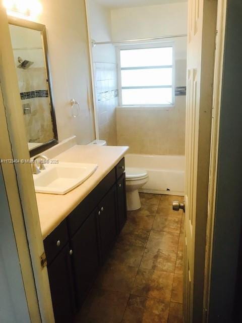 full bathroom with vanity, toilet, and tiled shower / bath combo