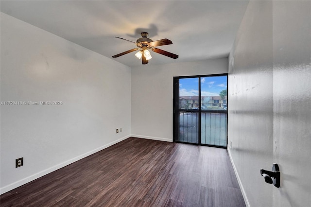 unfurnished room featuring ceiling fan and dark wood-type flooring