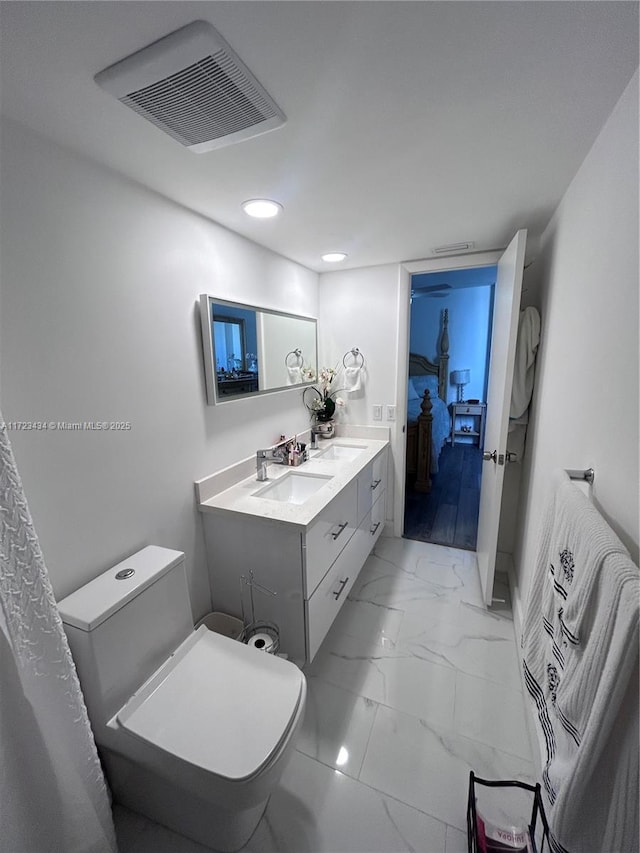 bathroom featuring vanity and toilet