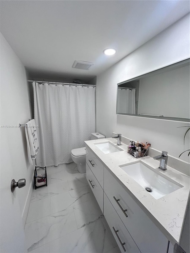 bathroom featuring vanity, curtained shower, and toilet