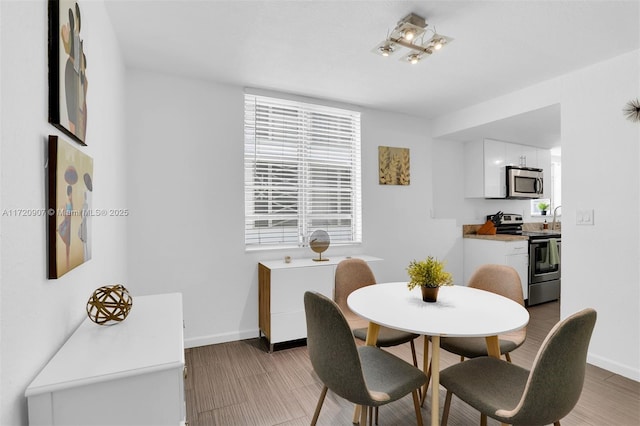 dining space with wood-type flooring