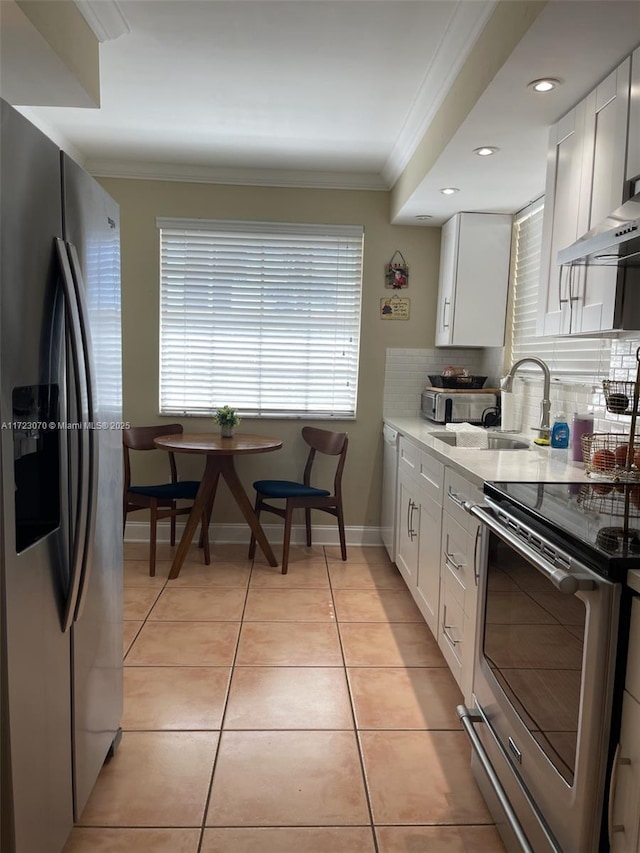 kitchen featuring white cabinetry, appliances with stainless steel finishes, and tasteful backsplash