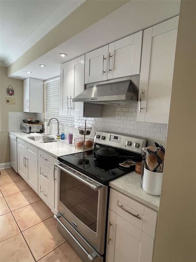 kitchen featuring stainless steel electric range, white dishwasher, sink, range hood, and white cabinetry