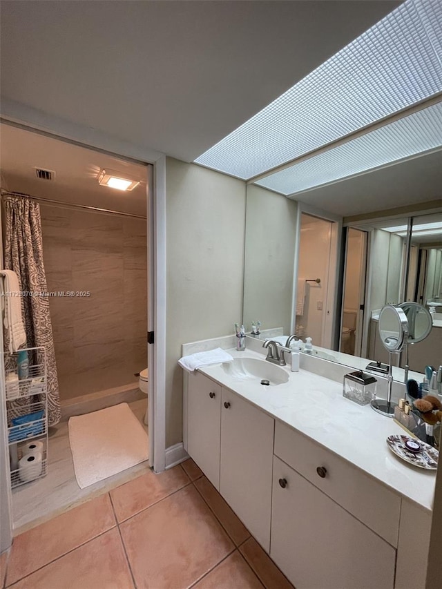 bathroom featuring toilet, tile patterned flooring, vanity, and a shower with shower curtain