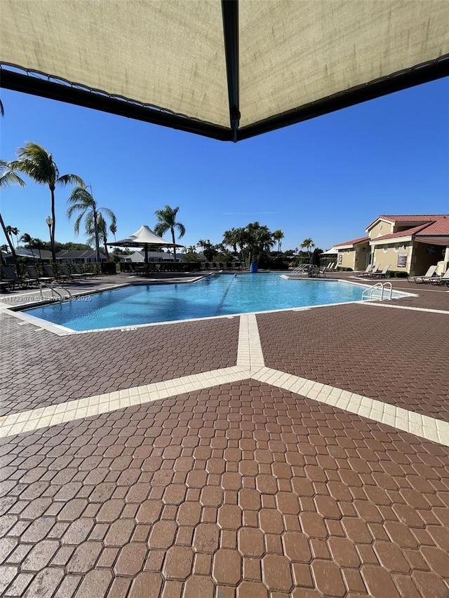 view of swimming pool featuring a gazebo and a patio