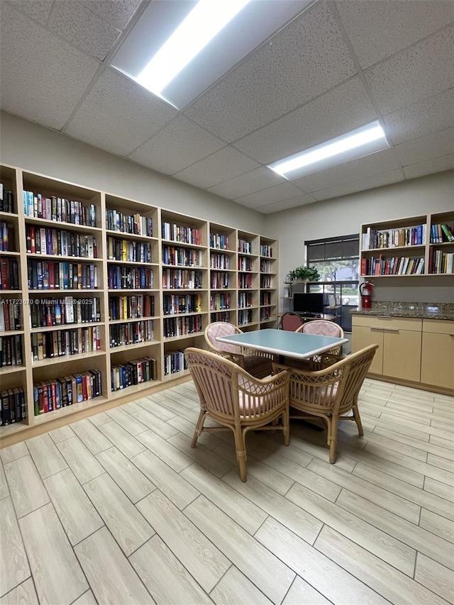 office with a drop ceiling and light hardwood / wood-style floors