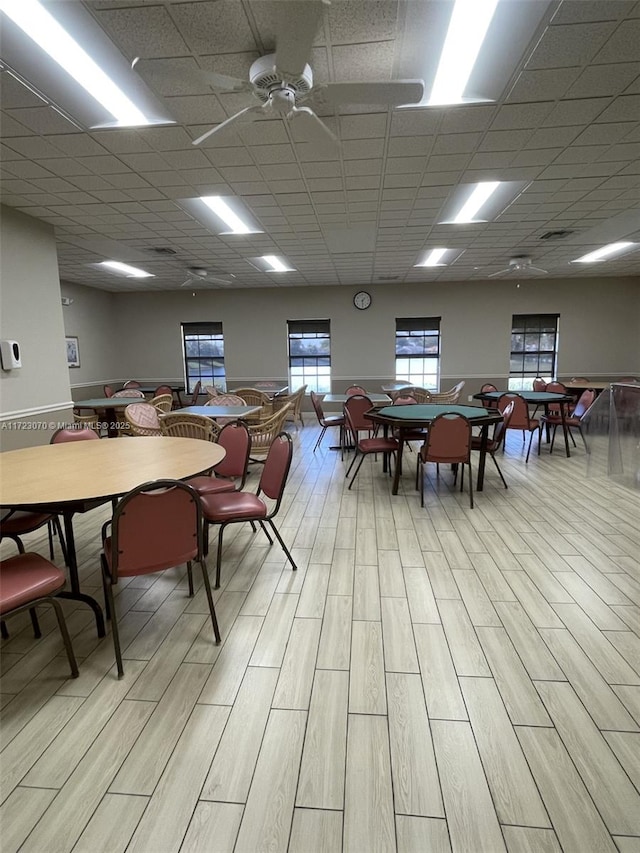 dining room with a paneled ceiling and ceiling fan