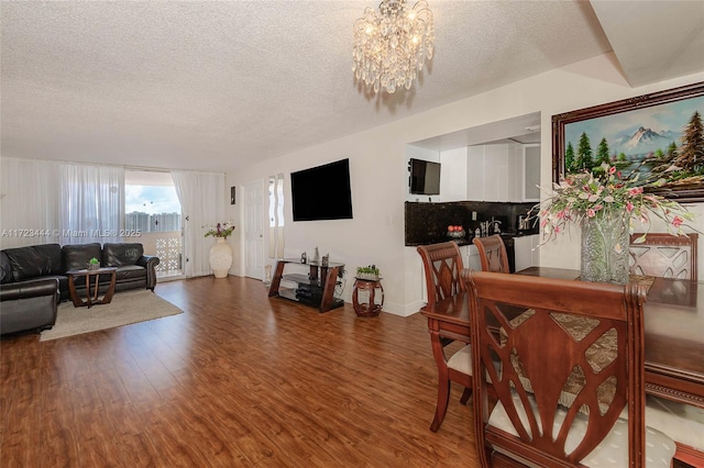 1833 S Ocean Dr Unit 1808, Hallandale Beach, FL 33009 - dining area with a chandelier, wood finished floors, a textured ceiling, and baseboards