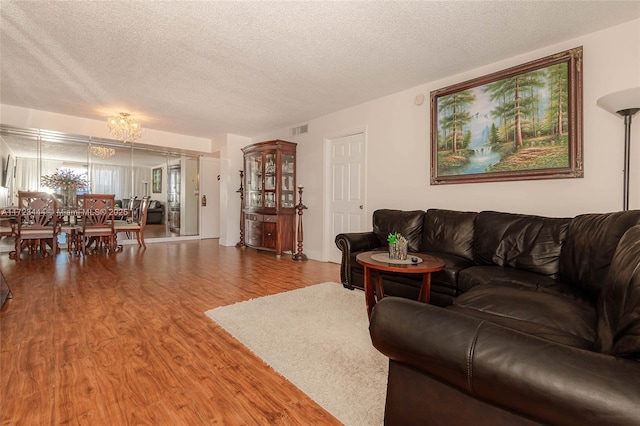 living room with hardwood / wood-style floors and a textured ceiling