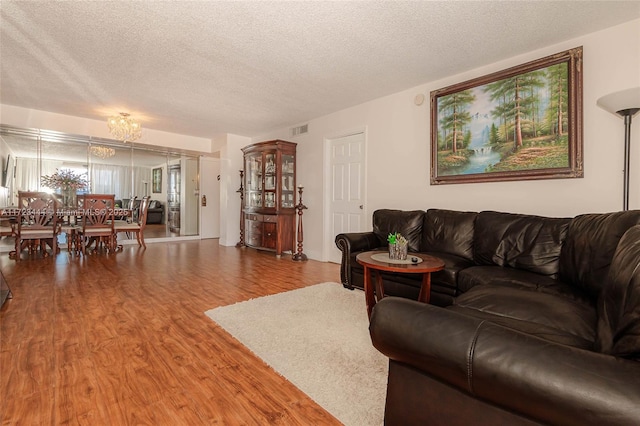 1833 S Ocean Dr Unit 1808, Hallandale Beach, FL 33009 - living area featuring wood finished floors, a textured ceiling, and a chandelier