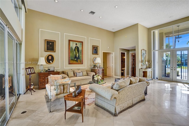 living room featuring french doors and a high ceiling