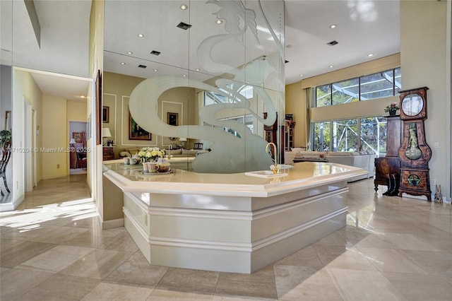 bathroom with sink and a towering ceiling