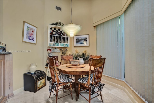 dining area with light tile patterned floors